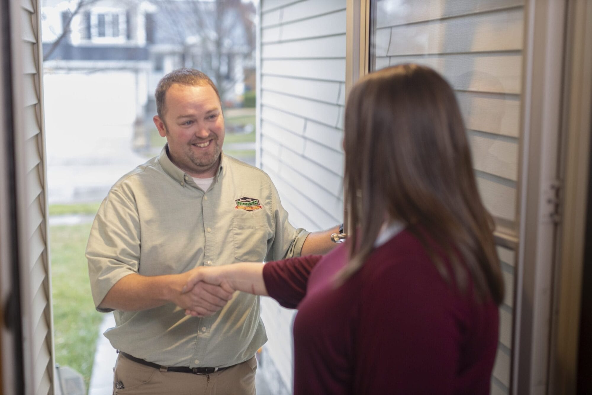 Greens technician greeting and shaking hands with customer